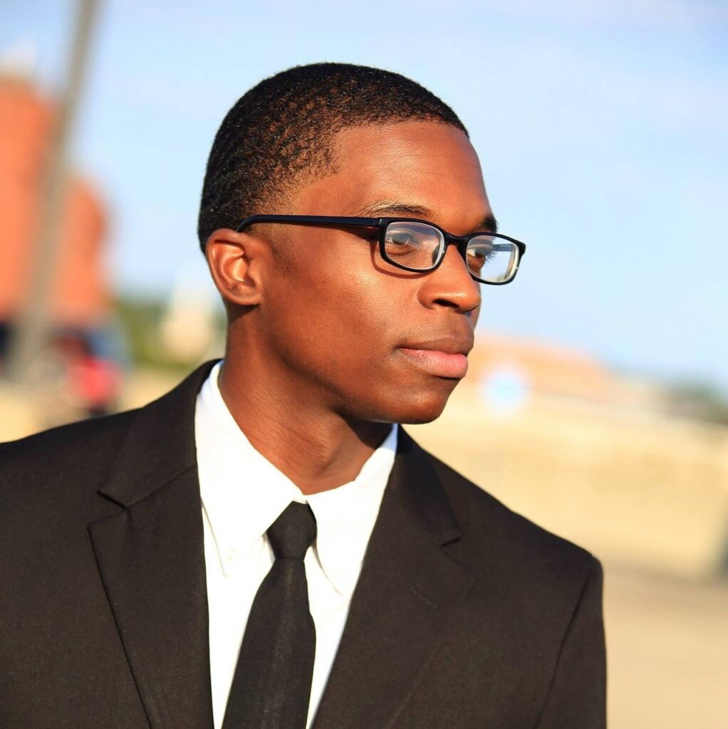 Photo of man in a business suit and glasses