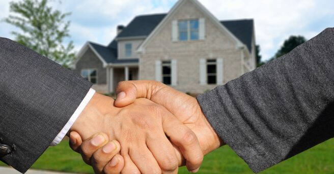 Handshake in front of a home