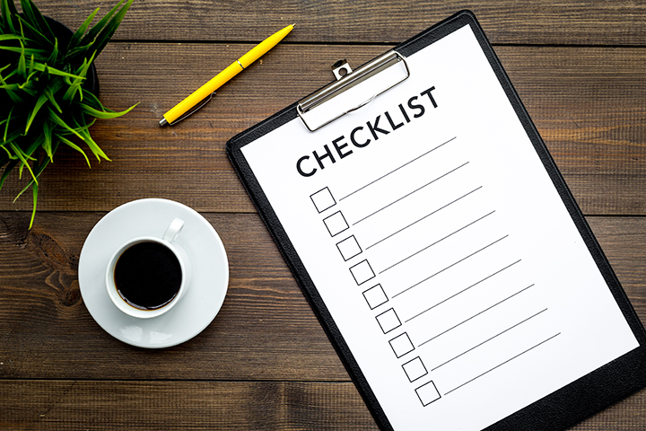 Blank checklist with space for ticks on a pad on an office desk.