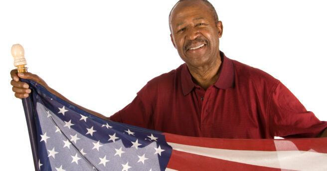 Older person holds American flag
