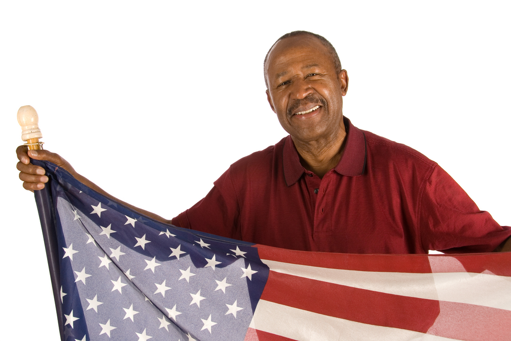 Older person holds American flag