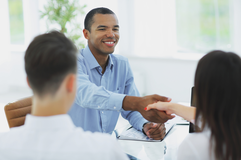 Person shaking hands with a couple
