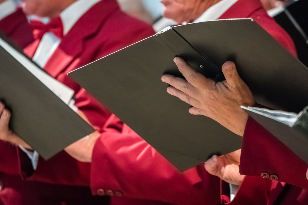 Close-up of hands holding sheet music