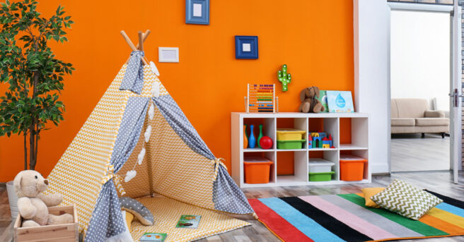 Cozy kids room interior with play tent and toys.