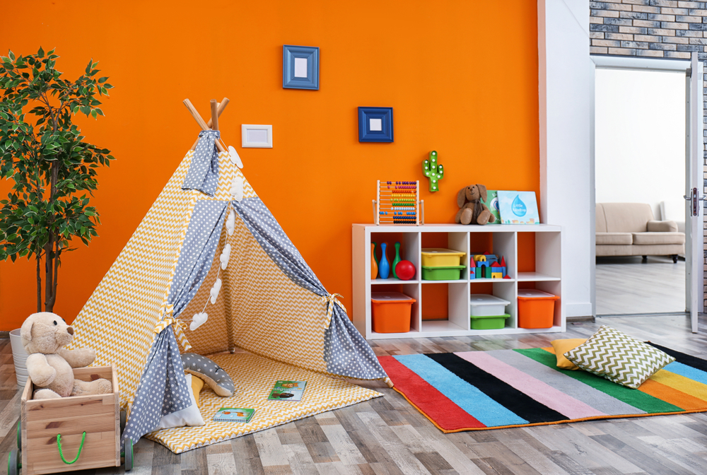 Cozy kids room interior with play tent and toys.