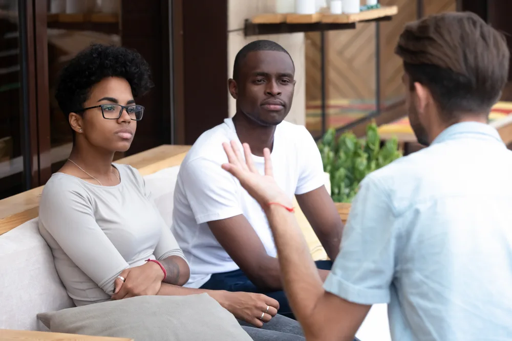 Adult talking to friends outside.
