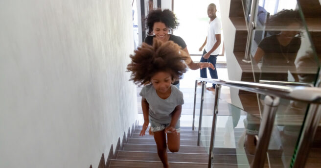 Parent and child walking upstairs