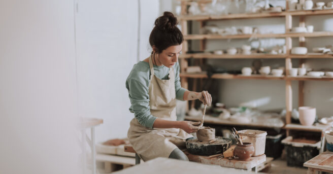 Person working on pottery in a studio