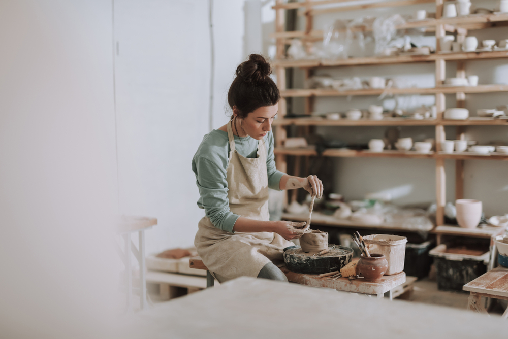 Person working on pottery in a studio