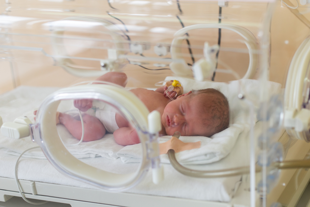 Premature newborn baby in the hospital incubator. Neonatal intensive care unit