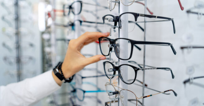 Person selecting eyeglasses