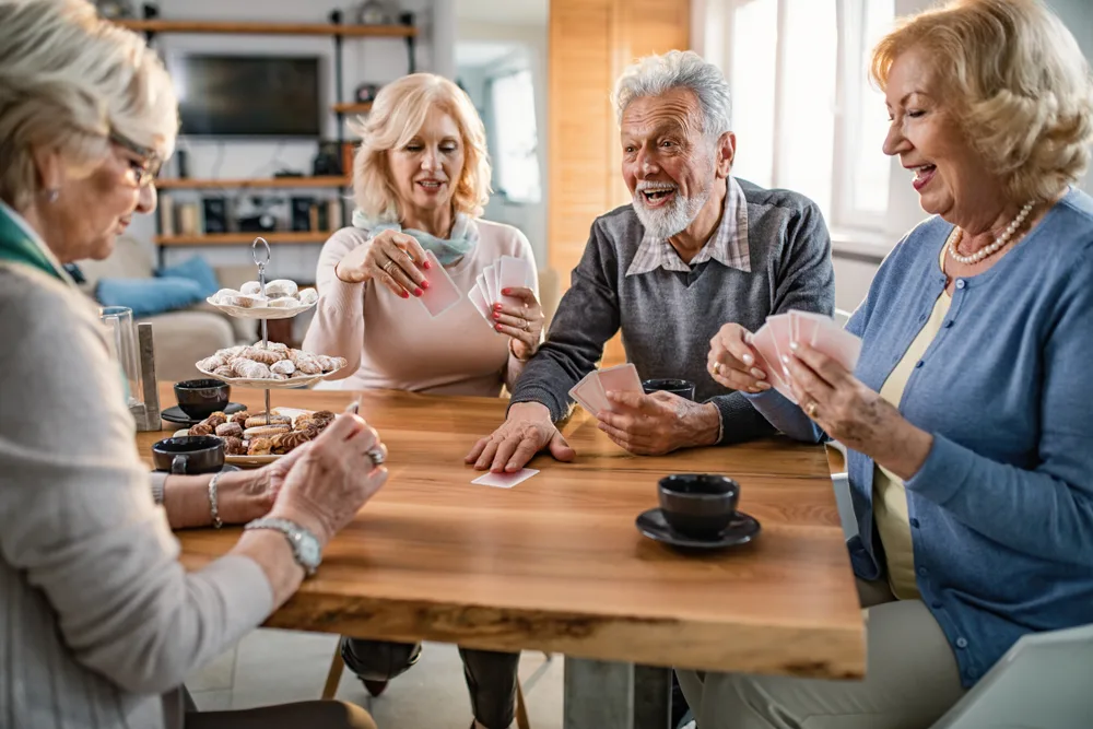 group of older adults play cards