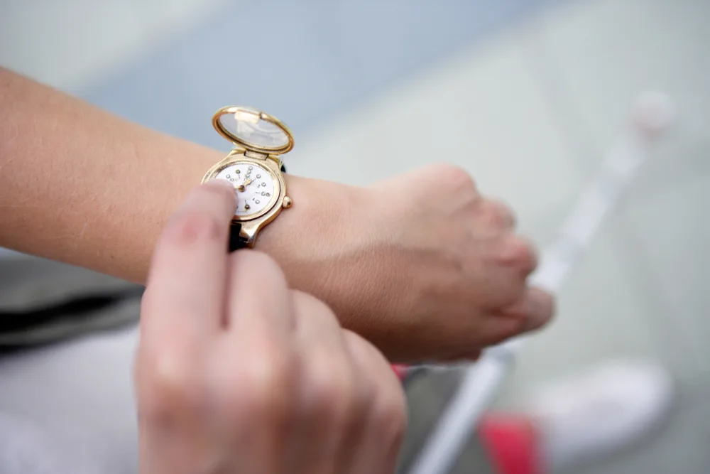 Person using a braille watch by touch