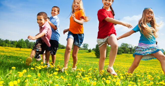 Five happy diversity looking children running in the park