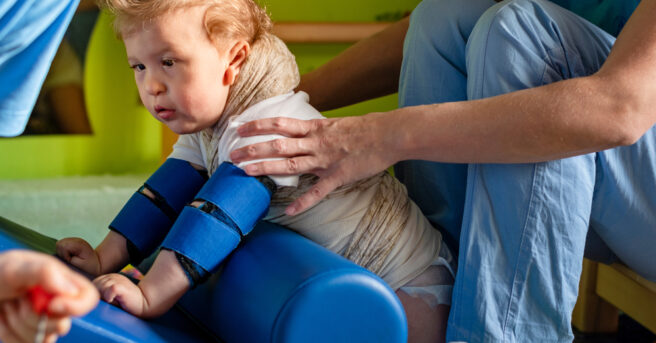 A child with cerebral palsy on physiotherapy in a children therapy center.