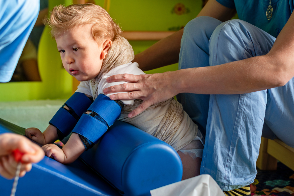 A child with cerebral palsy on physiotherapy in a children therapy center.