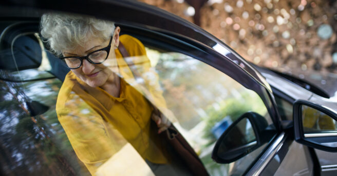 Older person stepping out of a vehicle