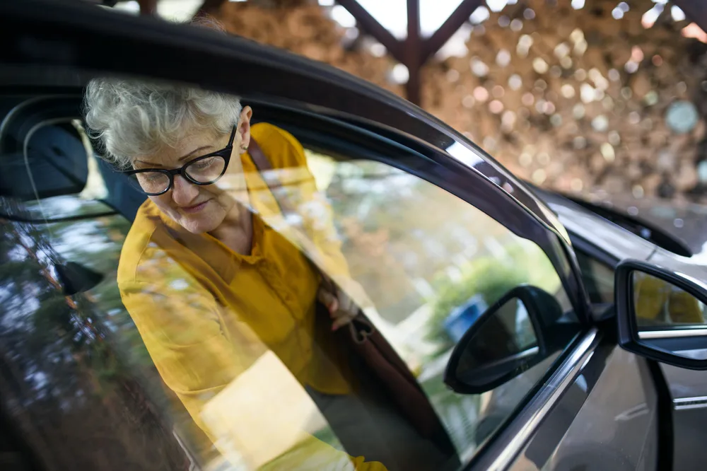 Older person stepping out of a vehicle
