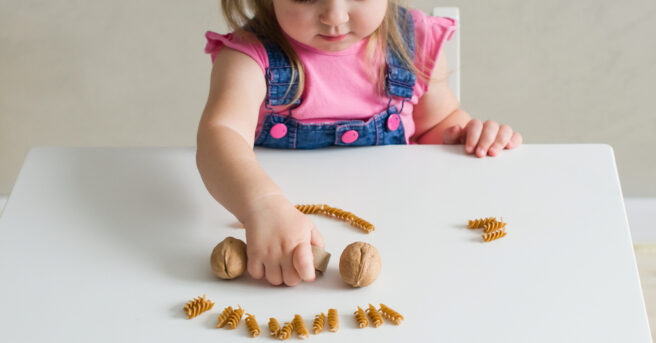 A little girl playing with natural materials. 