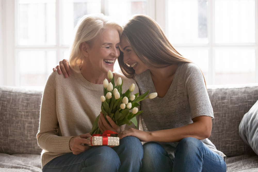 Older adult receives flowers and a gift