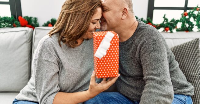 Couple embraces as a gift is presented