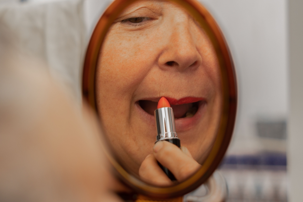 person applying lipstick