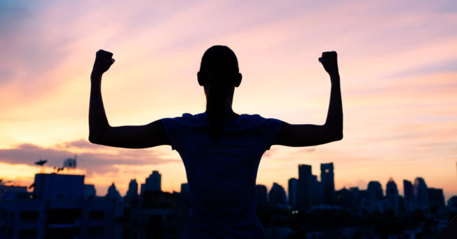 Silhouette of a person showing their muscles with confidence