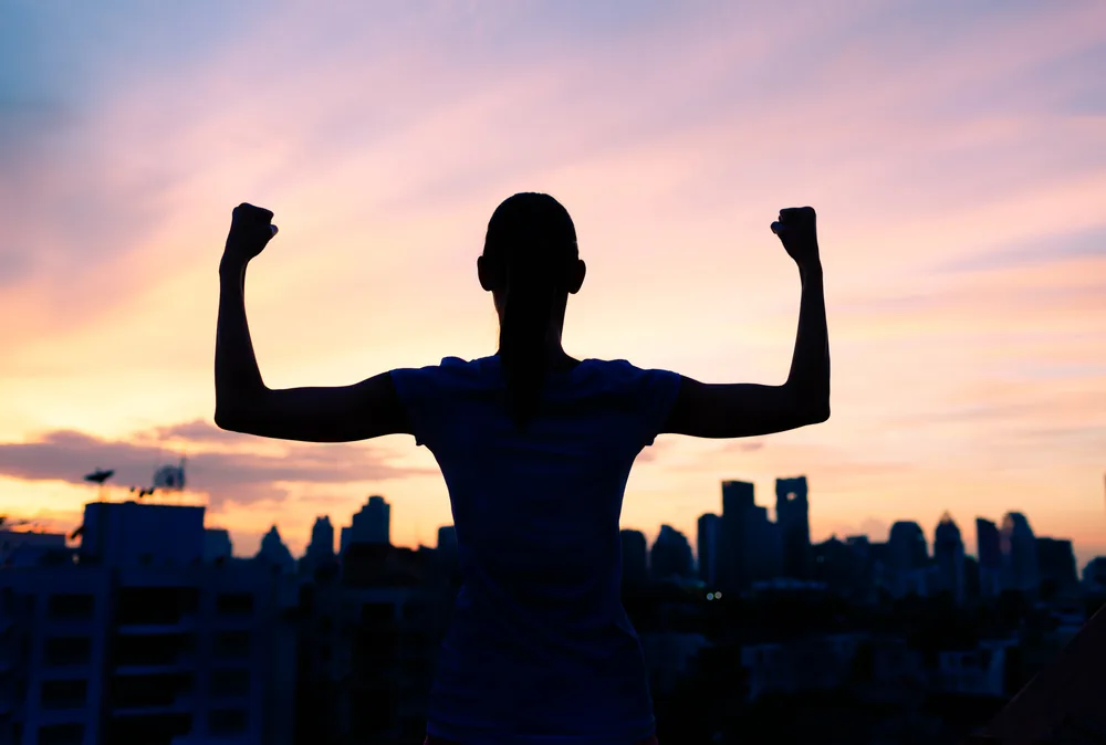 Silhouette of a person showing their muscles with confidence