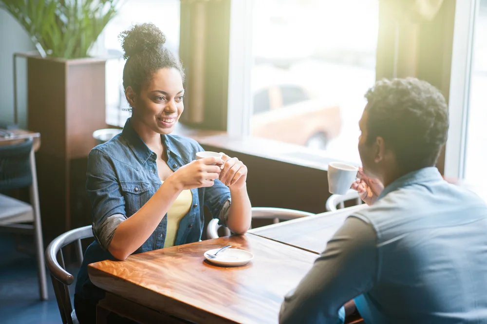 Two people drink tea at a restaurant