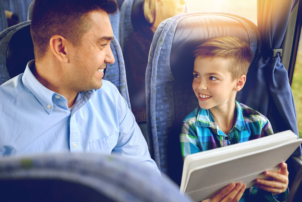 Adult and child traveling by bus