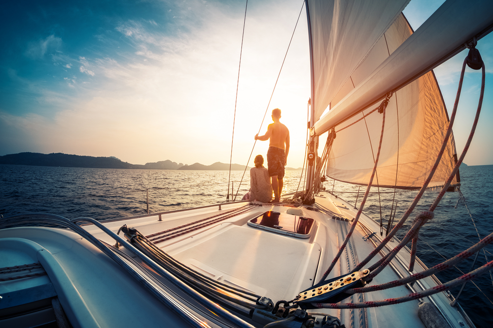 Two people on the back of a sailboat