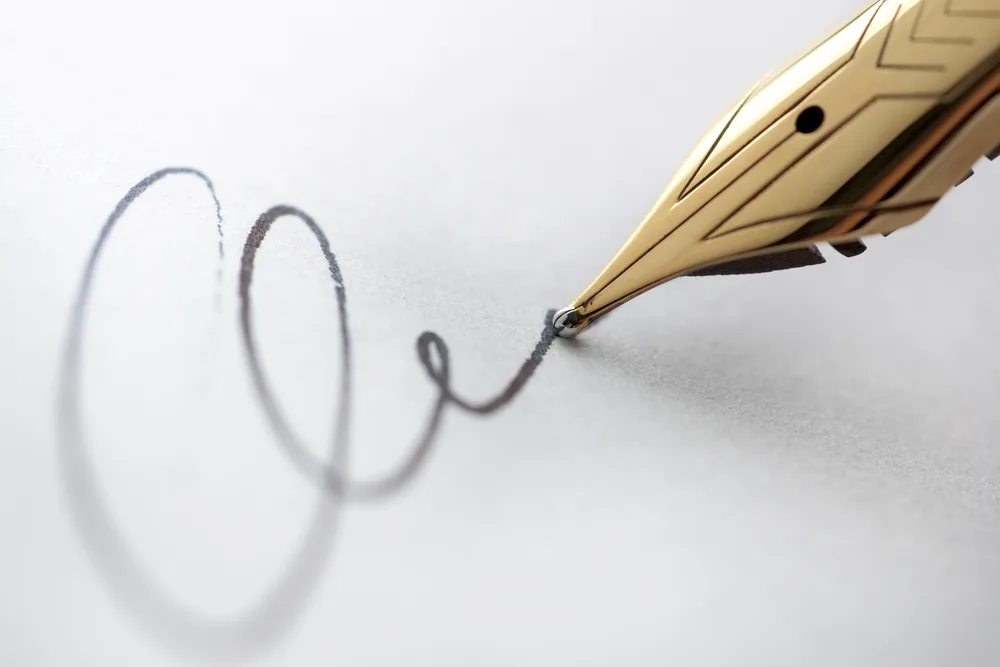 Close-up of a signature being written