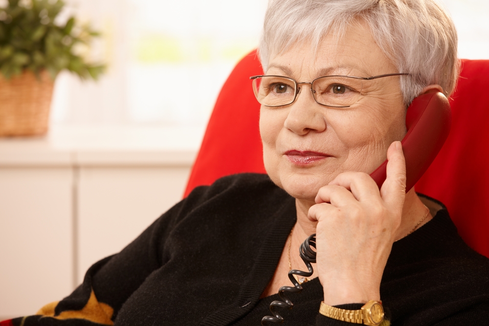 Older person using a landline telephone