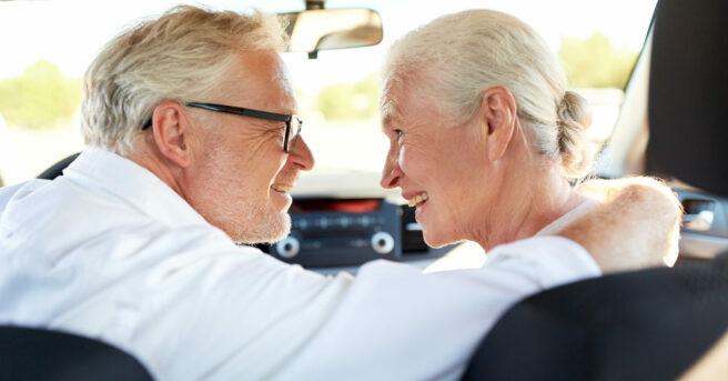 Older couple embracing in the car