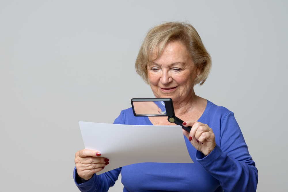 Person using a handheld magnifier