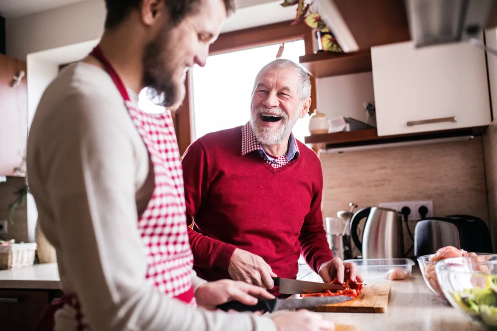 Two adults cooking in the kitchen