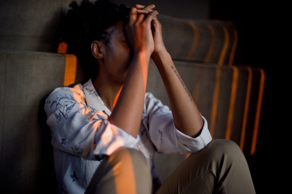 Young person with their head in their hands