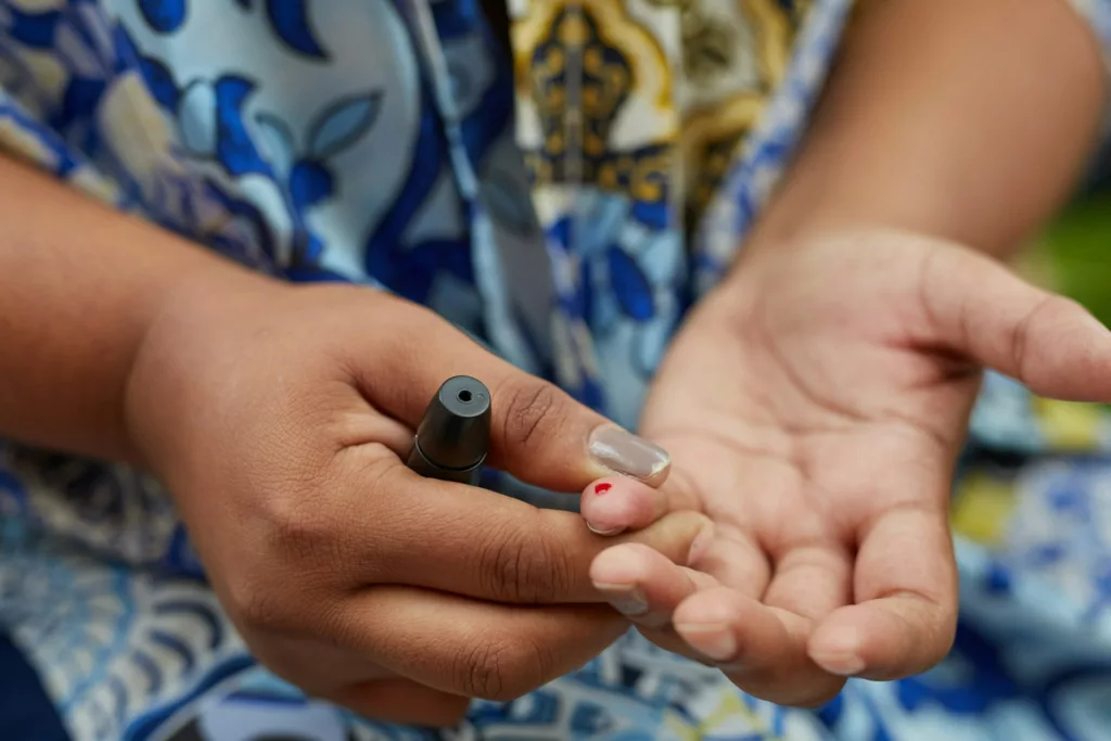 person testing blood glucose