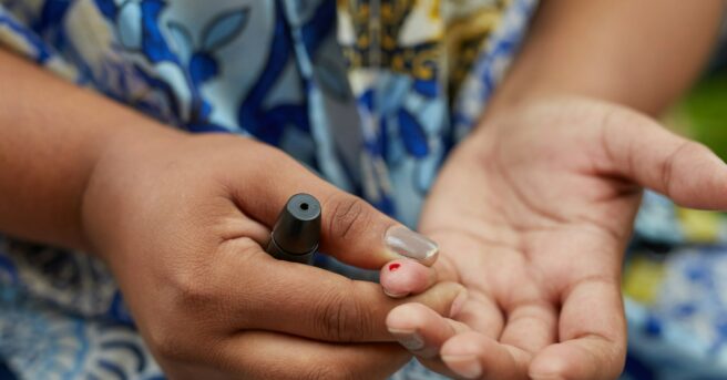 person testing blood glucose