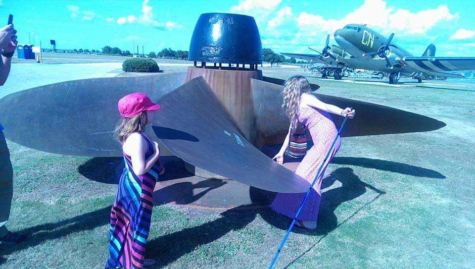 To children exploring the propeller from a plane.