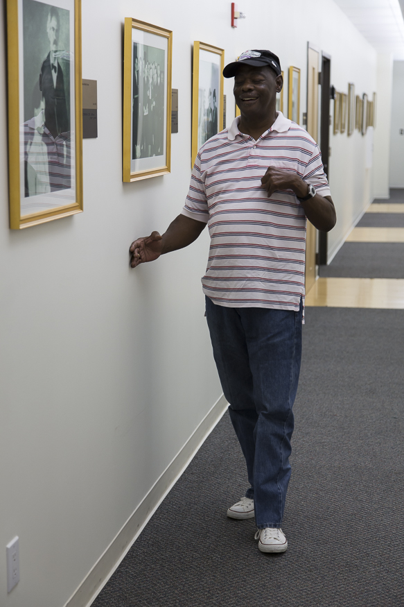 Person trailing a wall--holding their right hand with curled fingers against a wall and proceeding forward